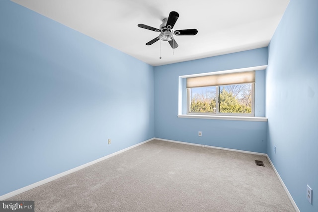 spare room with carpet floors and ceiling fan