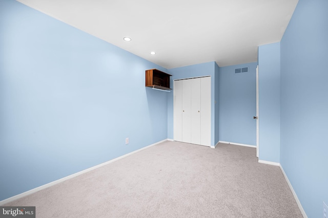 unfurnished bedroom featuring carpet flooring and a closet