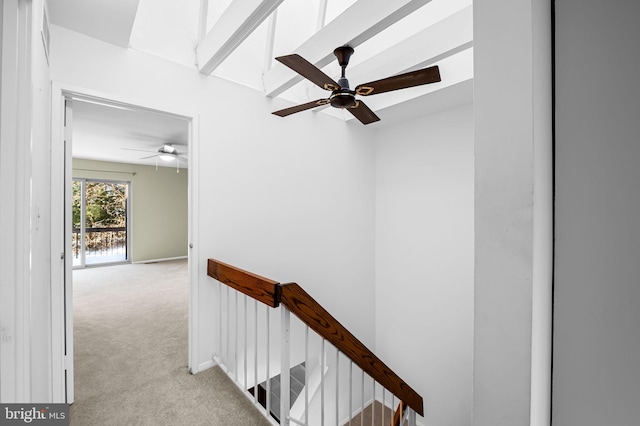 corridor featuring light carpet and vaulted ceiling