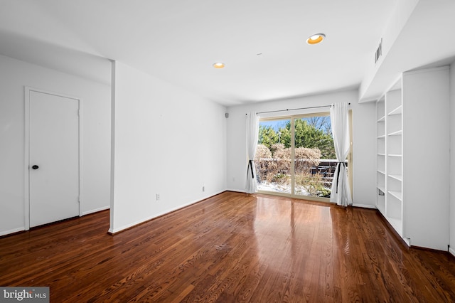 spare room with dark hardwood / wood-style flooring