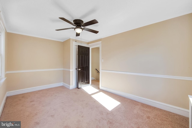 unfurnished bedroom with light carpet, ceiling fan, and ornamental molding