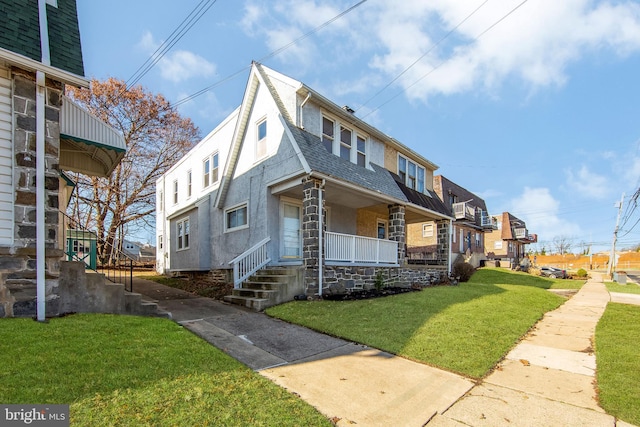 view of front of house with a porch and a front lawn