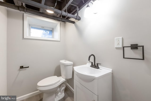 bathroom with hardwood / wood-style floors, vanity, and toilet