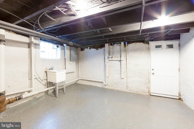 basement featuring sink and electric panel