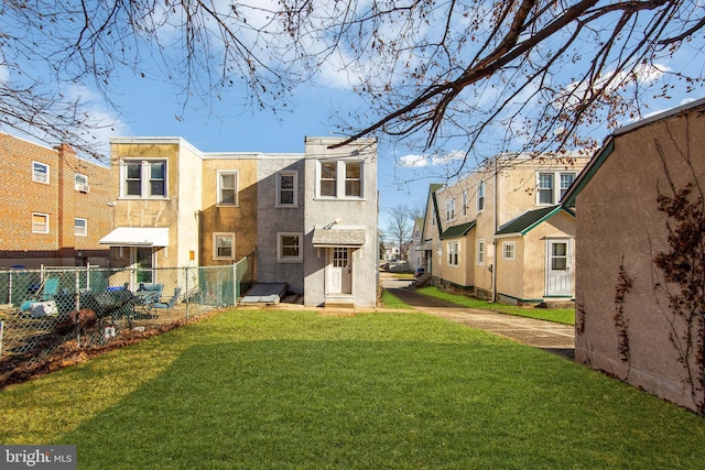 back of property featuring a lawn