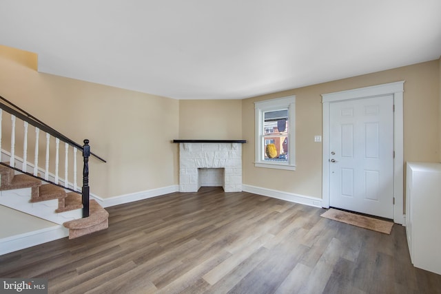 unfurnished living room featuring wood-type flooring and a fireplace