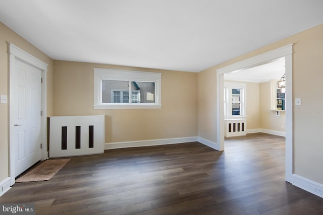 unfurnished room with dark hardwood / wood-style floors