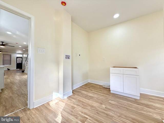 interior space with ceiling fan, light hardwood / wood-style floors, and hookup for a washing machine