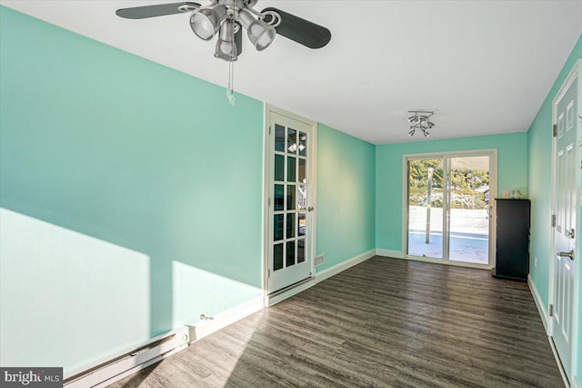 unfurnished dining area featuring ceiling fan, dark wood-type flooring, and a baseboard radiator