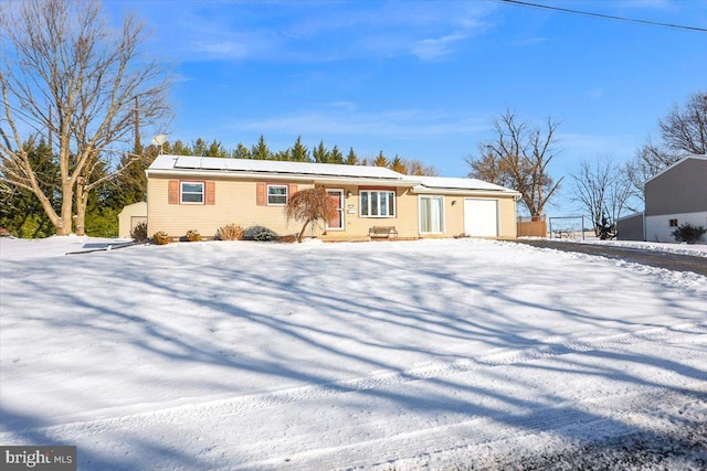 view of front of house with solar panels and a garage