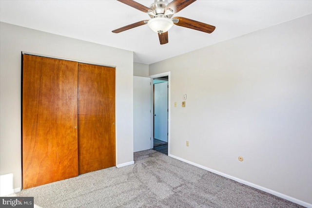 unfurnished bedroom featuring carpet floors, a closet, and ceiling fan