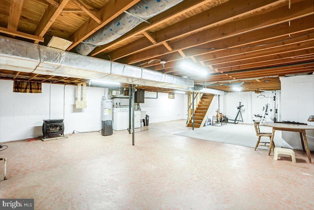 basement with electric water heater and a wood stove