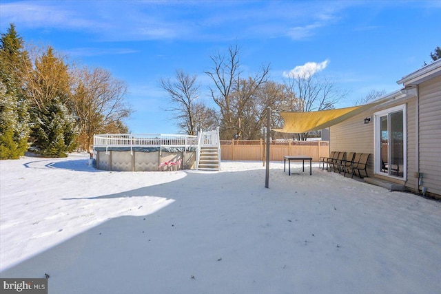 snowy yard with a covered pool