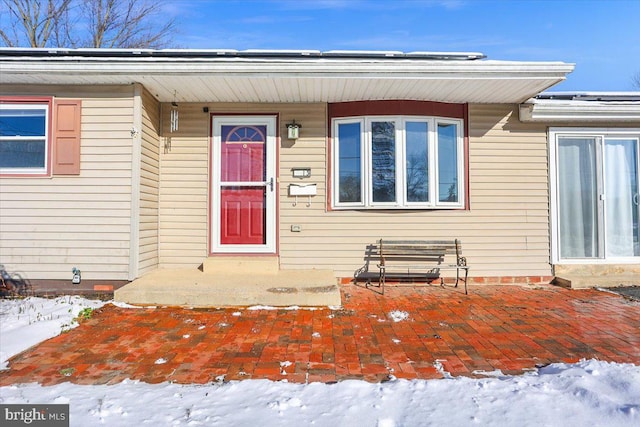 view of snow covered property entrance