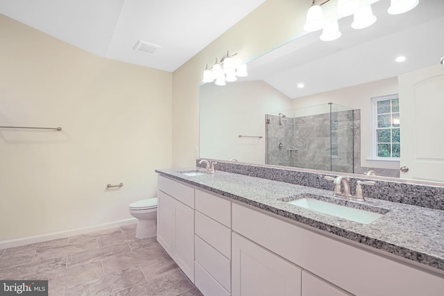 bathroom with vanity, a shower with shower door, and toilet