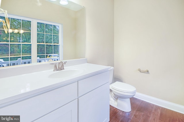 bathroom featuring vanity, toilet, and wood-type flooring