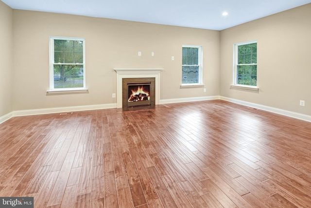 unfurnished living room with hardwood / wood-style floors