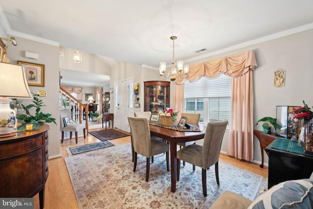 136 Sandpiper Ln, West Deptford, NJ 08086 - dining space with lofted ceiling, crown molding, light hardwood / wood-style flooring, and a chandelier