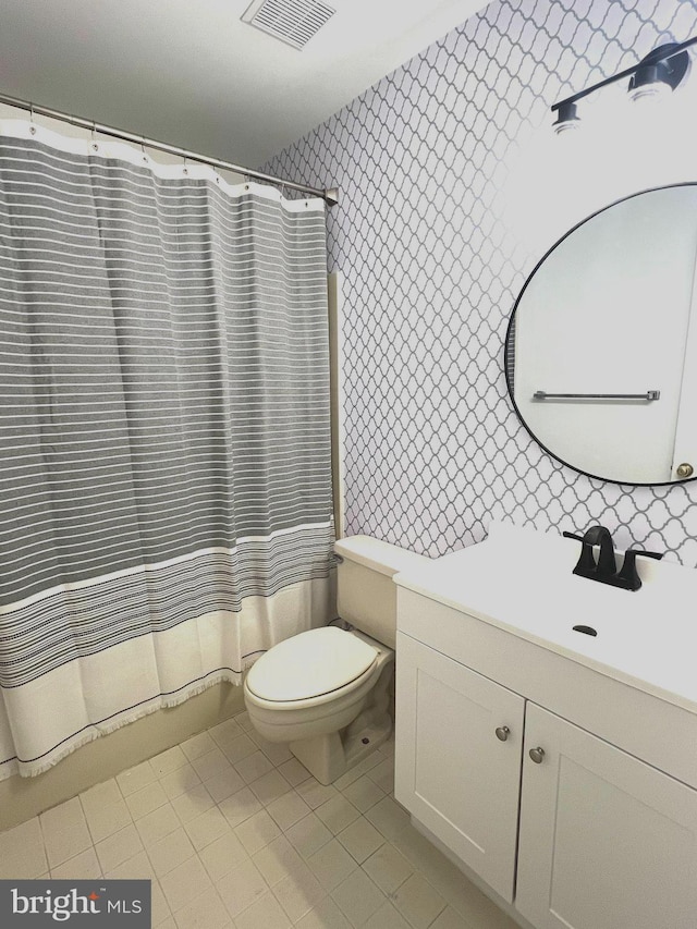 bathroom with tile patterned flooring, vanity, toilet, and a shower with shower curtain