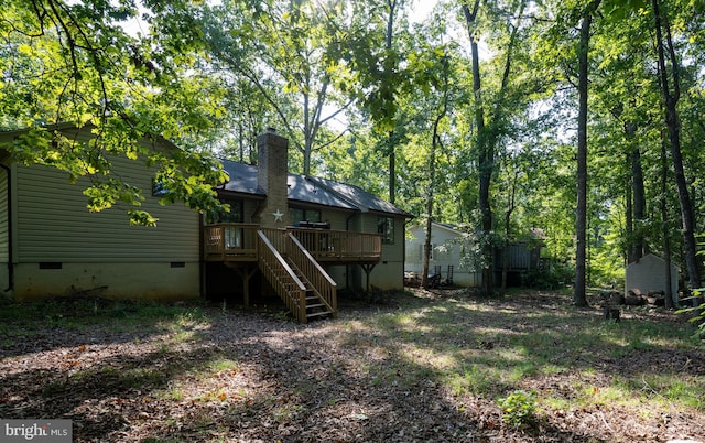 rear view of property with a wooden deck