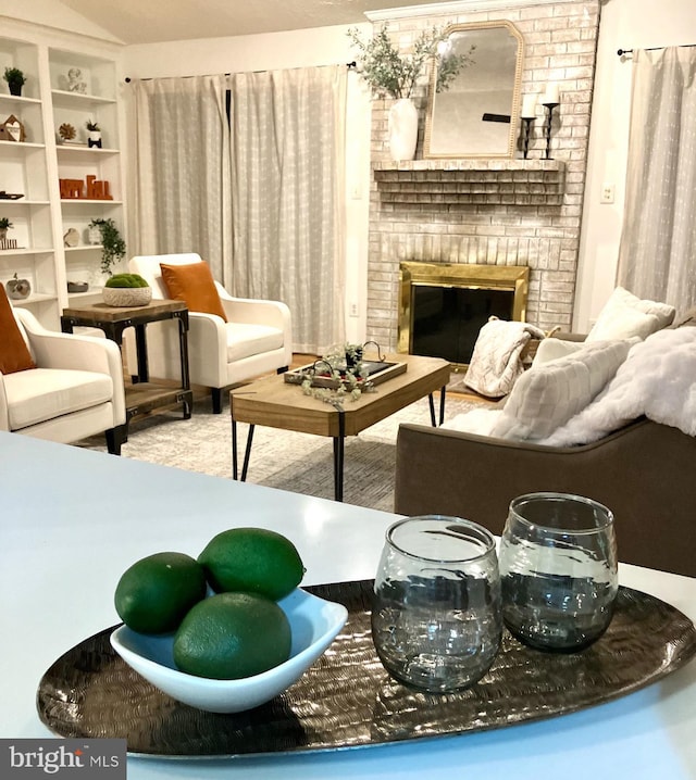 living area featuring a fireplace and lofted ceiling