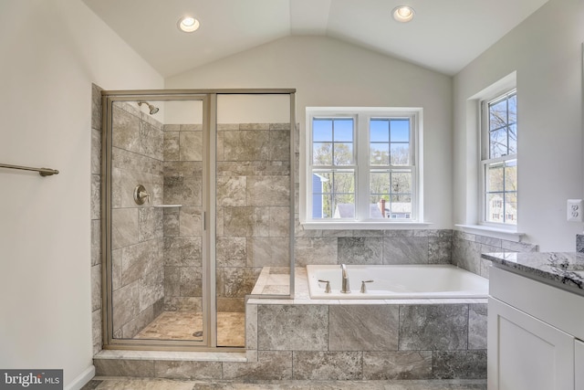 bathroom with vanity, independent shower and bath, and lofted ceiling