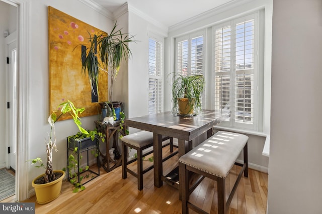 dining area featuring hardwood / wood-style floors and ornamental molding