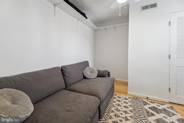 living room featuring ceiling fan and hardwood / wood-style floors