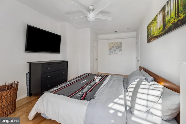 bedroom featuring ceiling fan and light hardwood / wood-style flooring