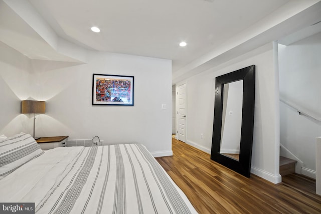 bedroom with dark hardwood / wood-style flooring