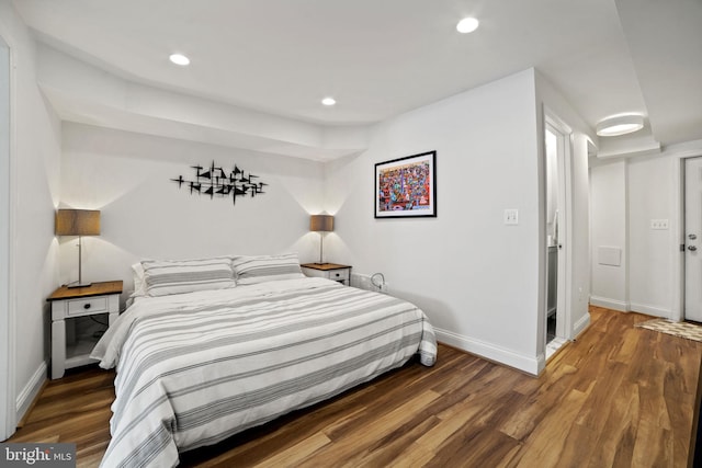 bedroom with dark wood-type flooring