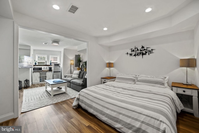 bedroom with dark hardwood / wood-style floors