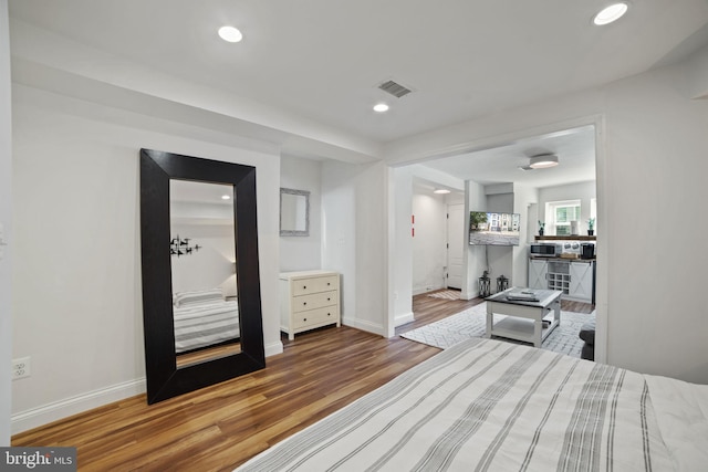 bedroom with hardwood / wood-style flooring