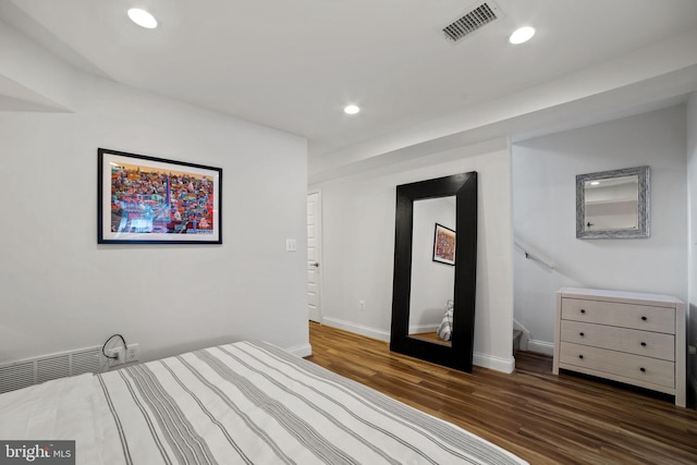 unfurnished bedroom with dark wood-type flooring