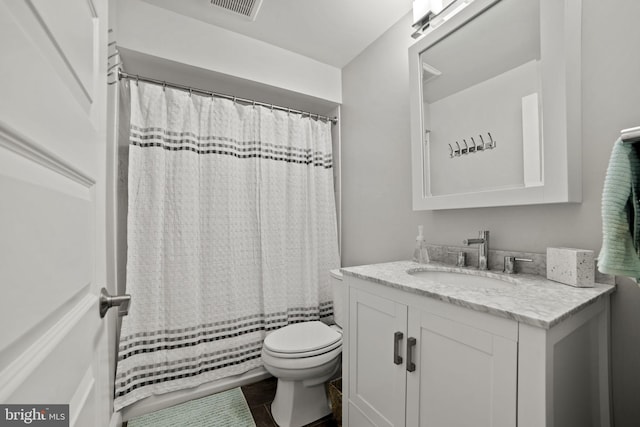 bathroom with tile patterned flooring, vanity, and toilet