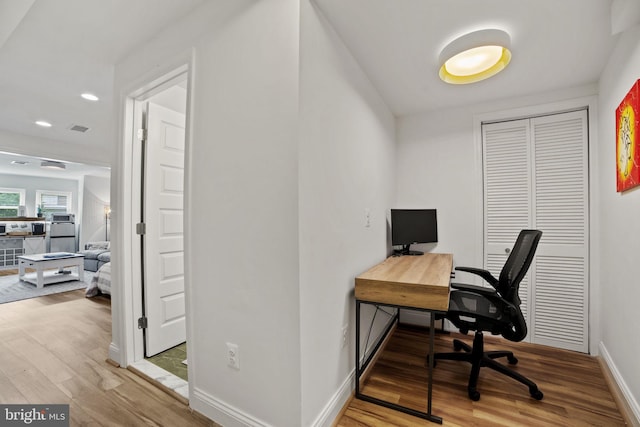 office with wood-type flooring