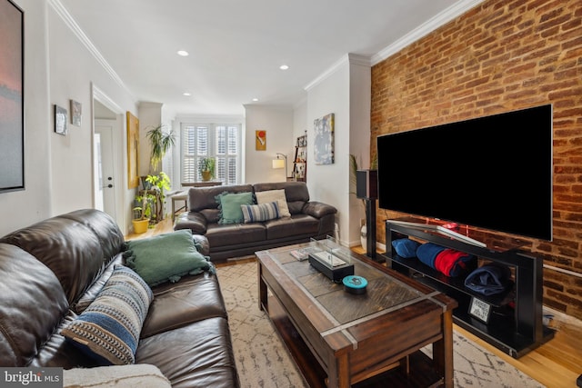 living room with light wood-type flooring, crown molding, and brick wall