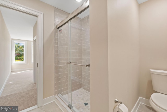 bathroom featuring walk in shower and toilet