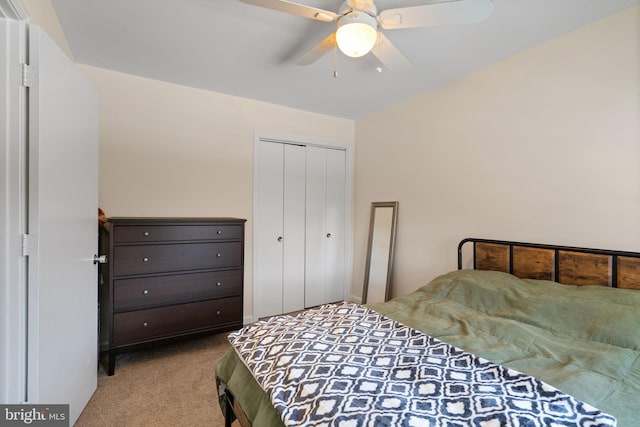 carpeted bedroom with ceiling fan and a closet