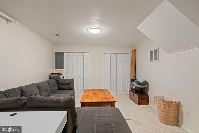 living room featuring ornamental molding, carpet, and electric panel