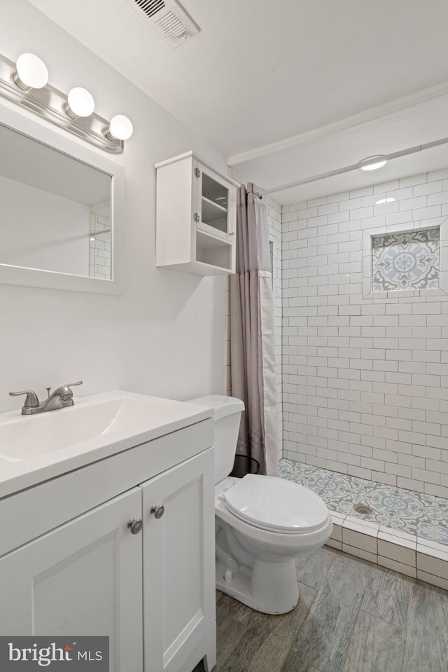 bathroom featuring vanity, curtained shower, toilet, and hardwood / wood-style flooring