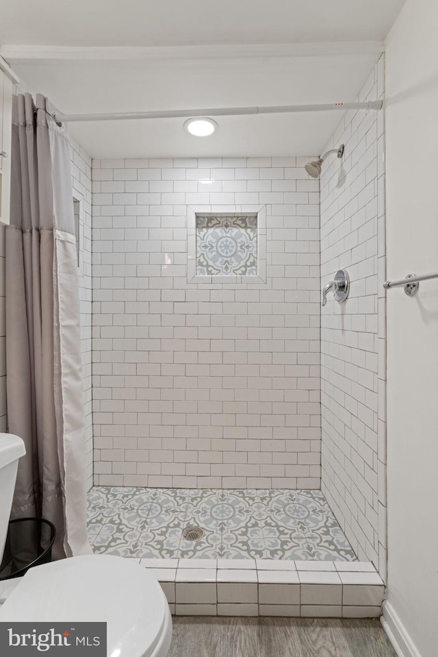 bathroom featuring curtained shower and toilet