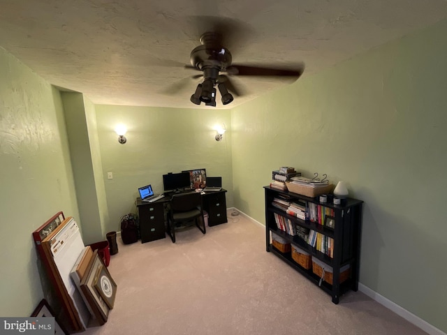 office space with light colored carpet, a textured ceiling, and ceiling fan