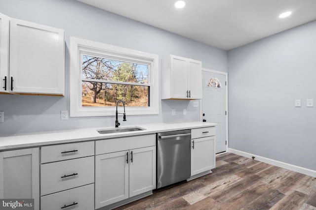 kitchen with dishwasher, white cabinetry, sink, and dark wood-type flooring