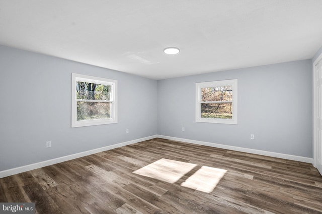 spare room with wood-type flooring