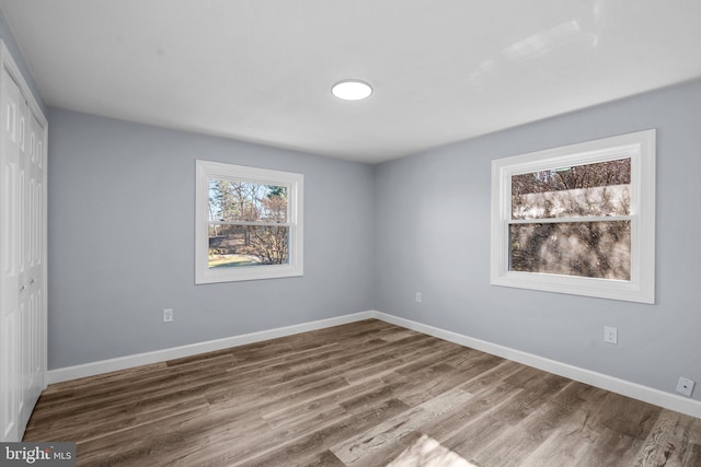 spare room with hardwood / wood-style flooring