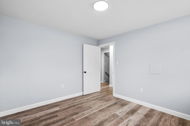 empty room with wood-type flooring