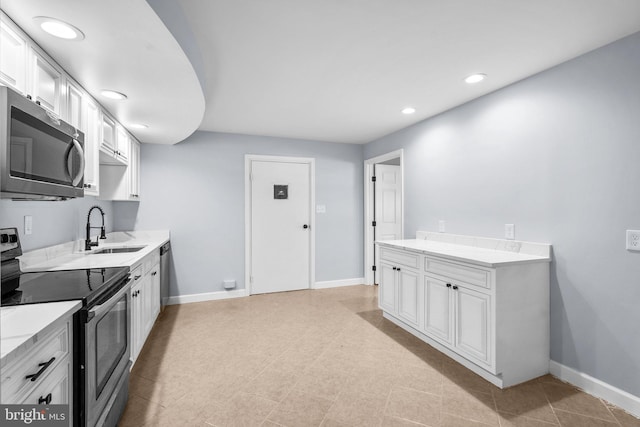 kitchen featuring sink, white cabinetry, and stainless steel appliances