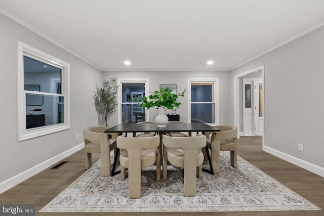 dining area featuring hardwood / wood-style floors and ornamental molding