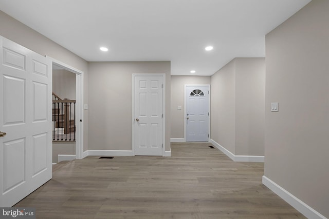 corridor with light hardwood / wood-style flooring